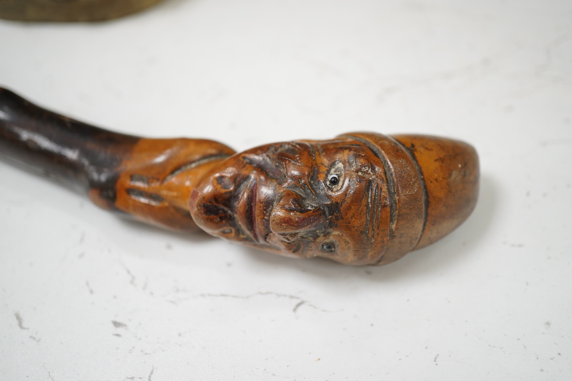 A carved rootwood walking stick, with carved novelty ‘Punch’ style head handle. 81cm high. Condition - some damage on stick.